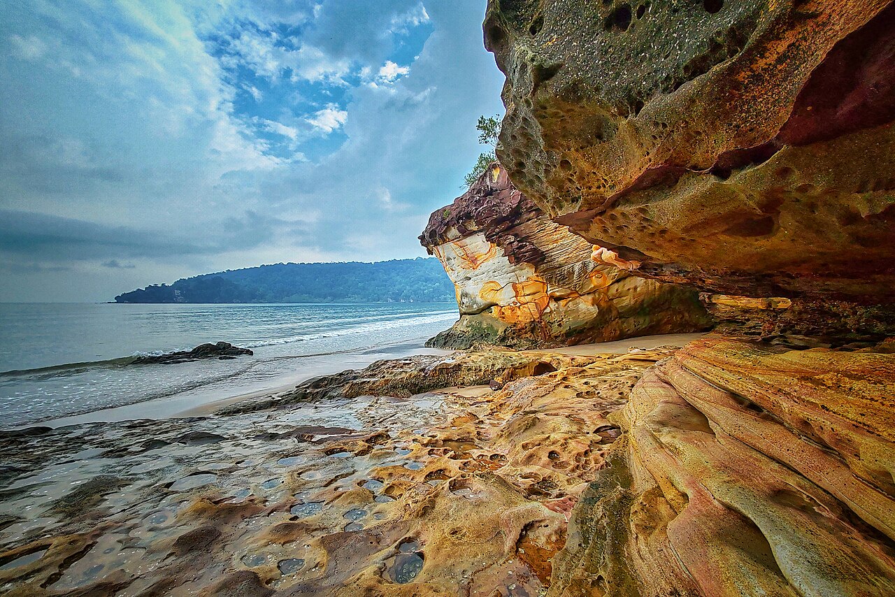 Layered sandstone cliffs on the beach at Bako National Park